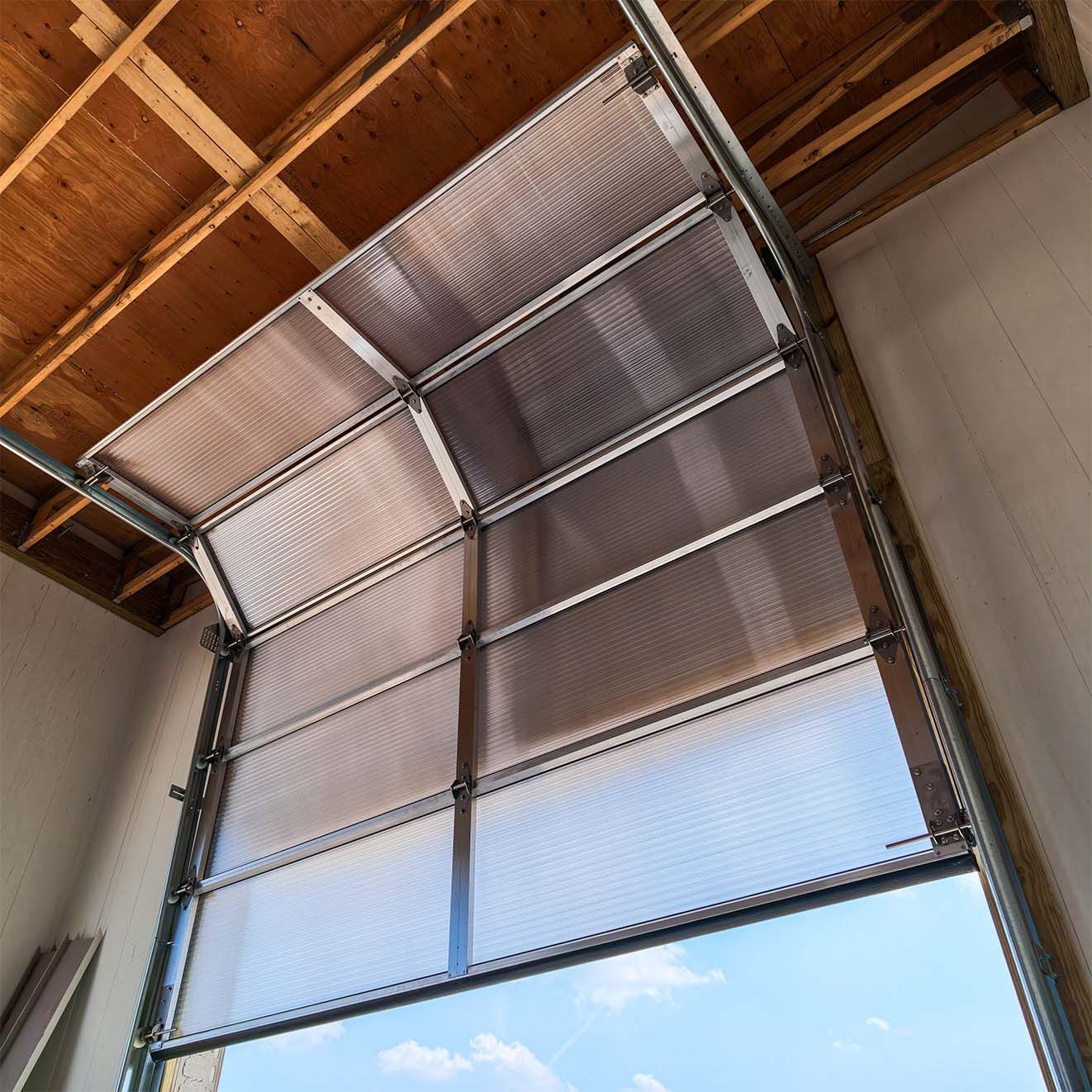 Survivor door assembled and raised on stainless steel high-lift track inside the wash bay