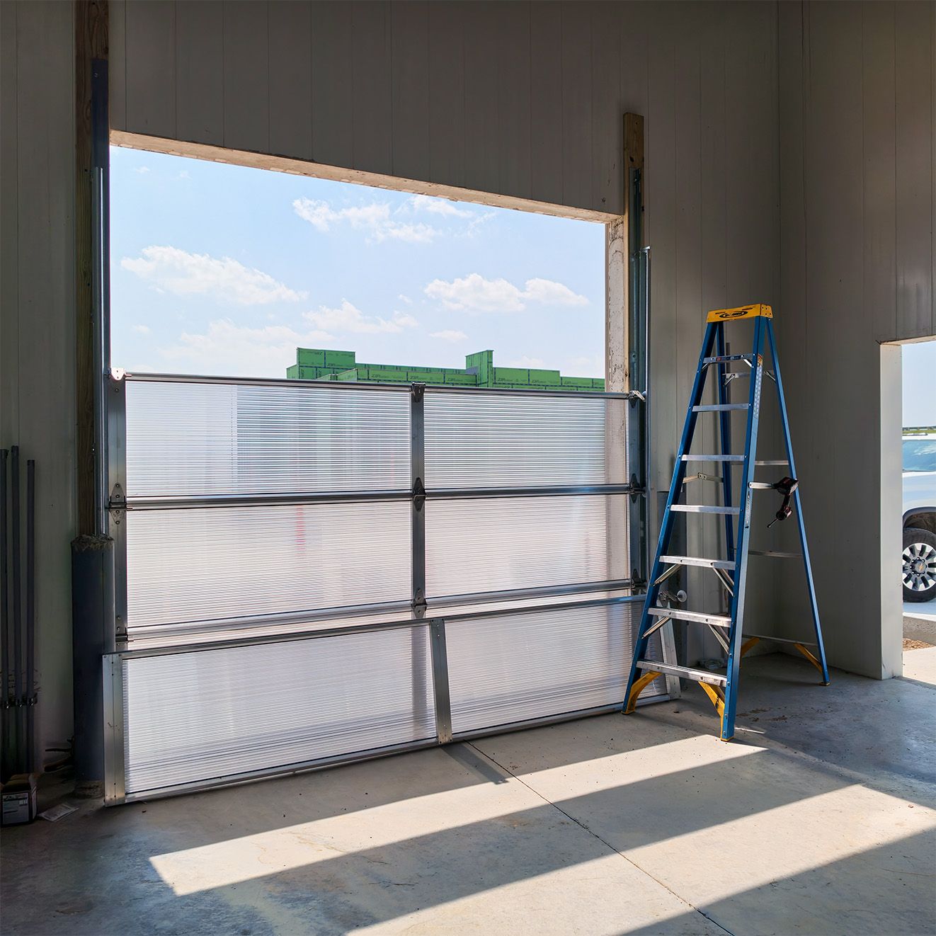 Survivor Platinum polycarbonate door partially installed in the wash bay opening