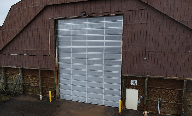 Archived DOT salt-storage facility with an oversized translucent overhead door