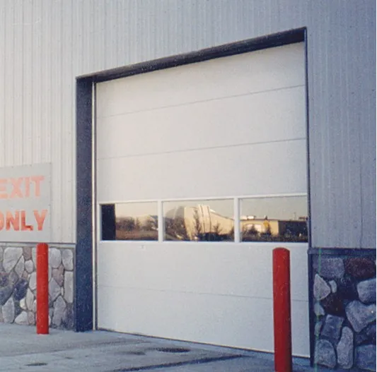 White insulated washbay door inside a lit wash bay with an exit only sign