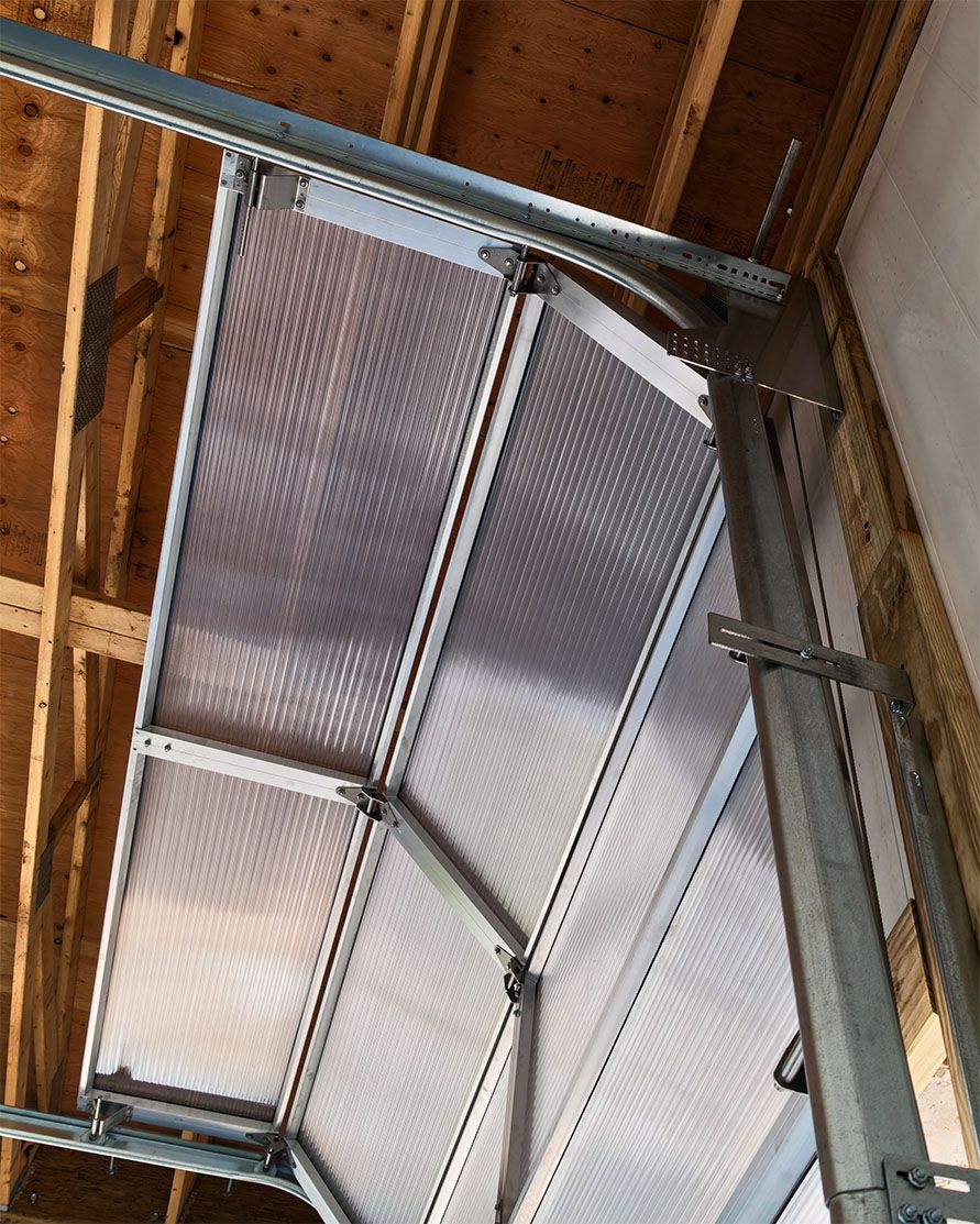 Detail of the high-lift track curve, stainless face hardware, and struts on the Survivor Platinum door