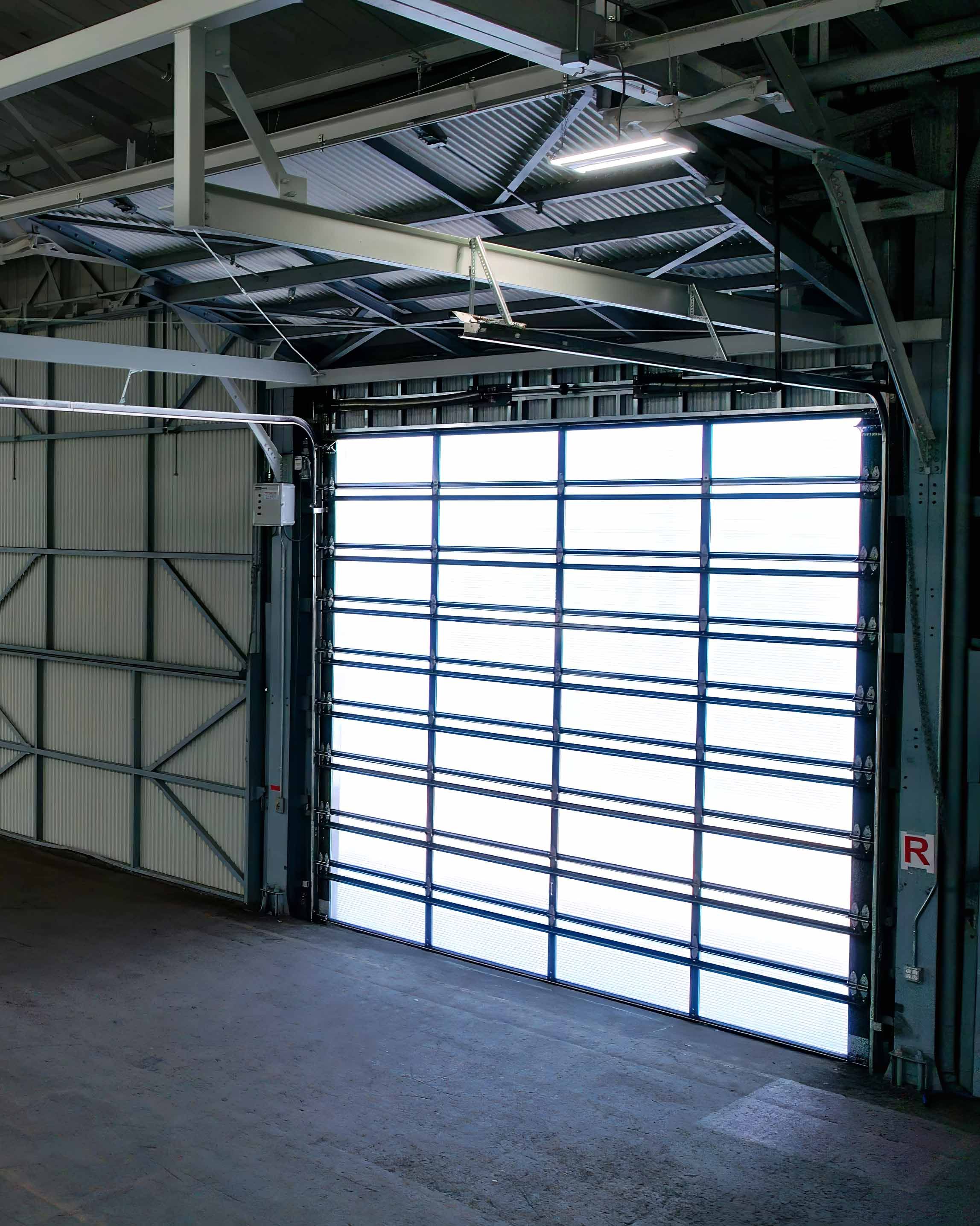 Interior view of a single closed translucent Survivor door under an open steel roof structure