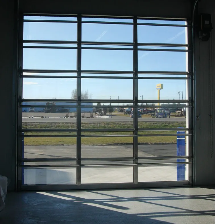 View through an UltraClear full-vision door from inside the bay to the parking lot