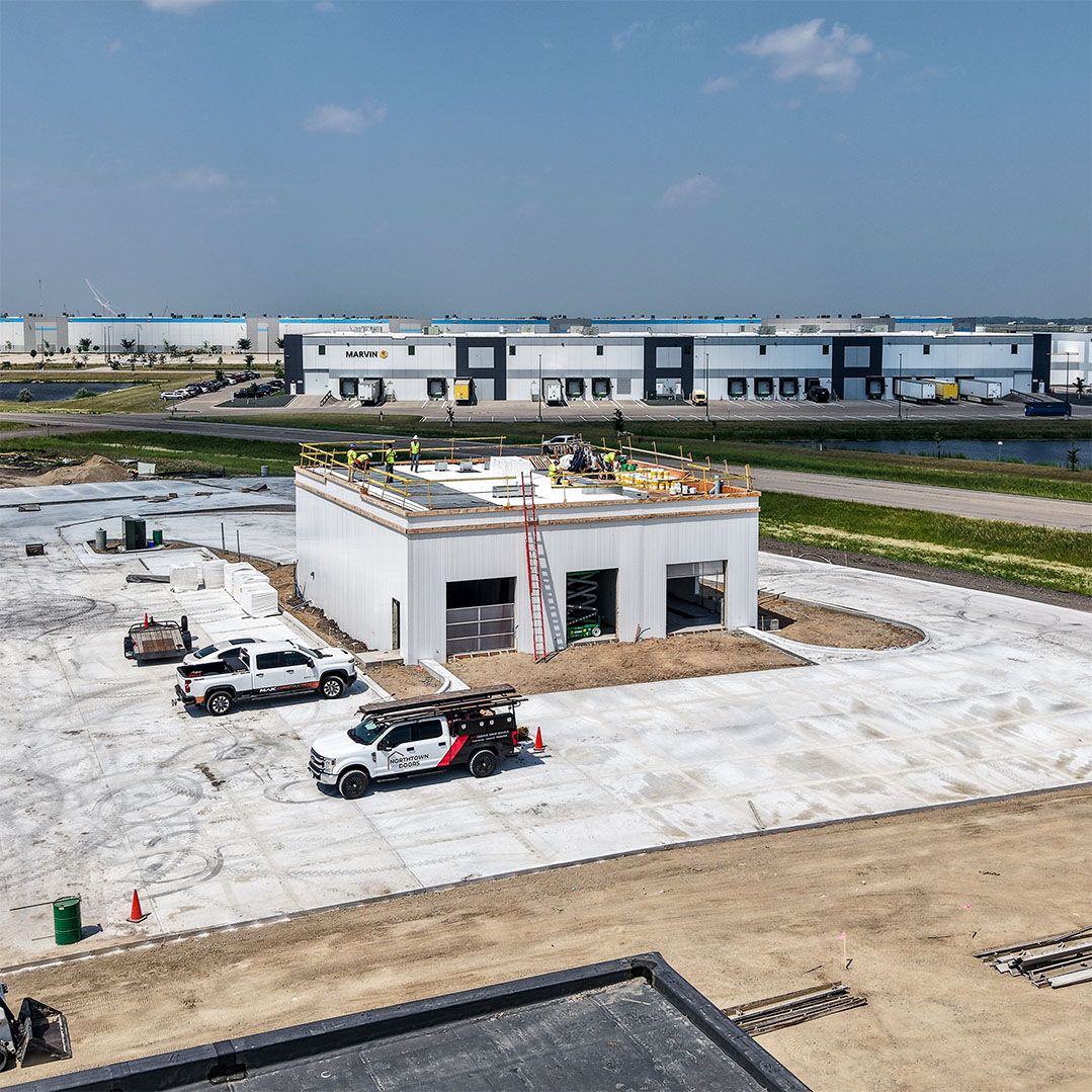 Aerial view of the Northdale Oil car wash building with the Marvin facility across the road