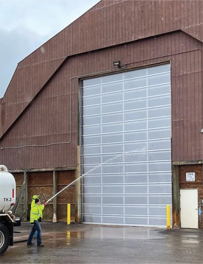 Tall Goliath door on a pole building with a water tanker truck being washed down in front of it